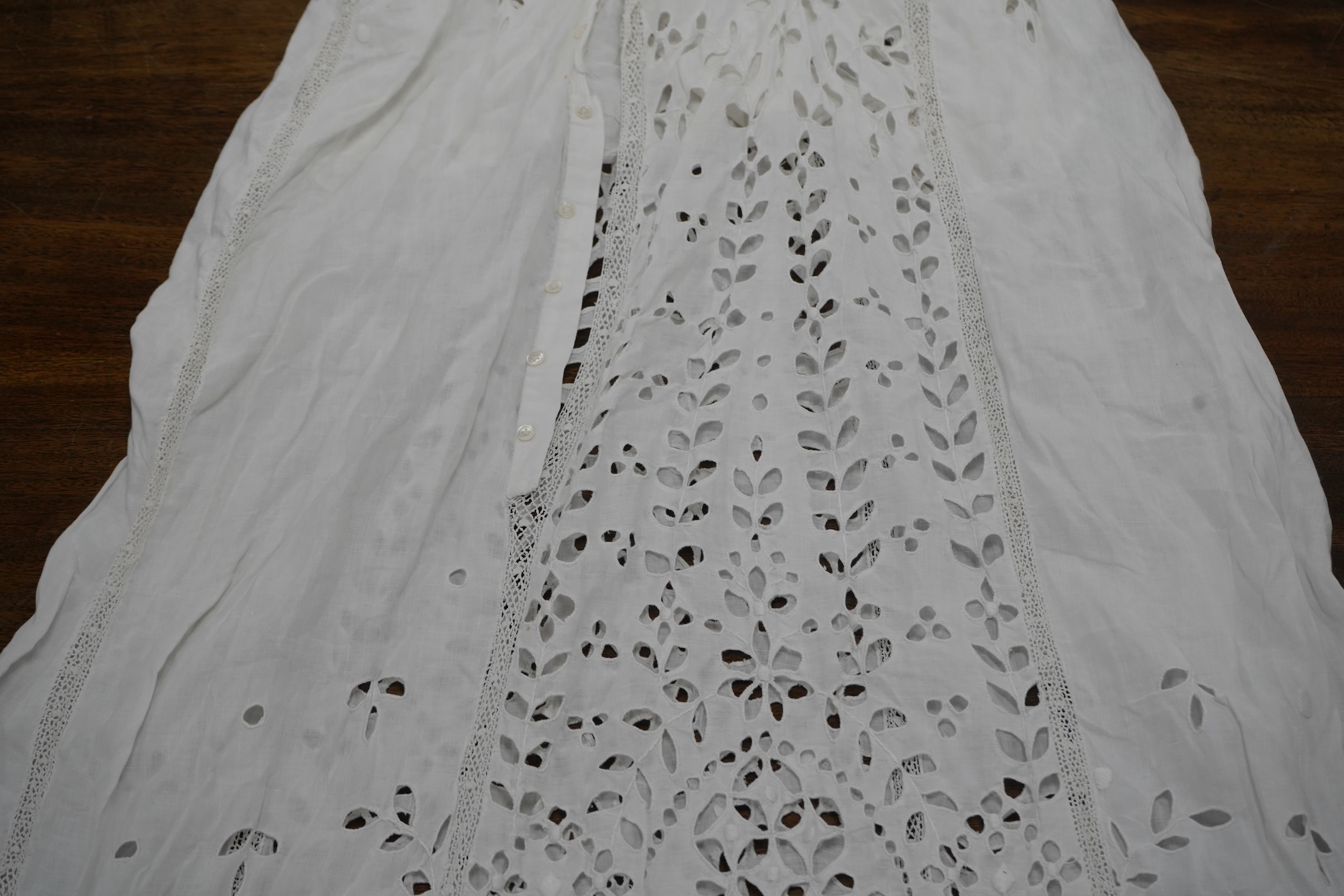 An Edwardian fine white embroidery anglaise and Irish crochet trimmed ladies summer dress, designed with large panels of anglaise cut work, the dress has been altered and restyled, which could be altered back, 134cm long